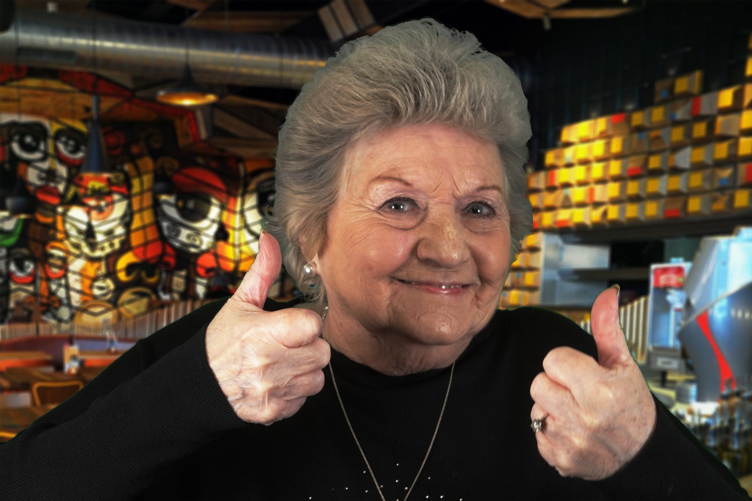 A smiling Nan does a thumbs up at Nando's